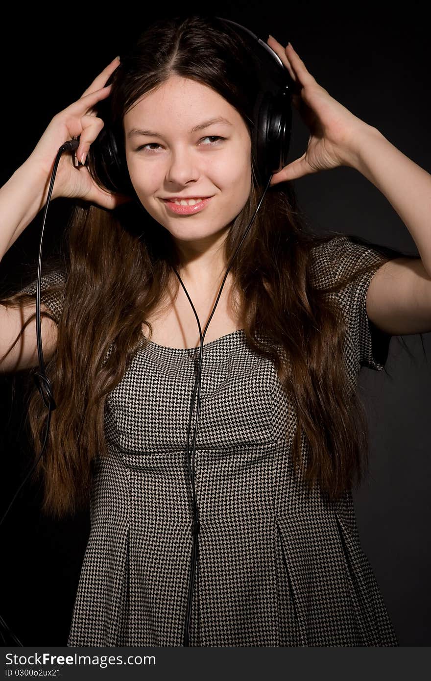 Young beauty girl in headphones listening music