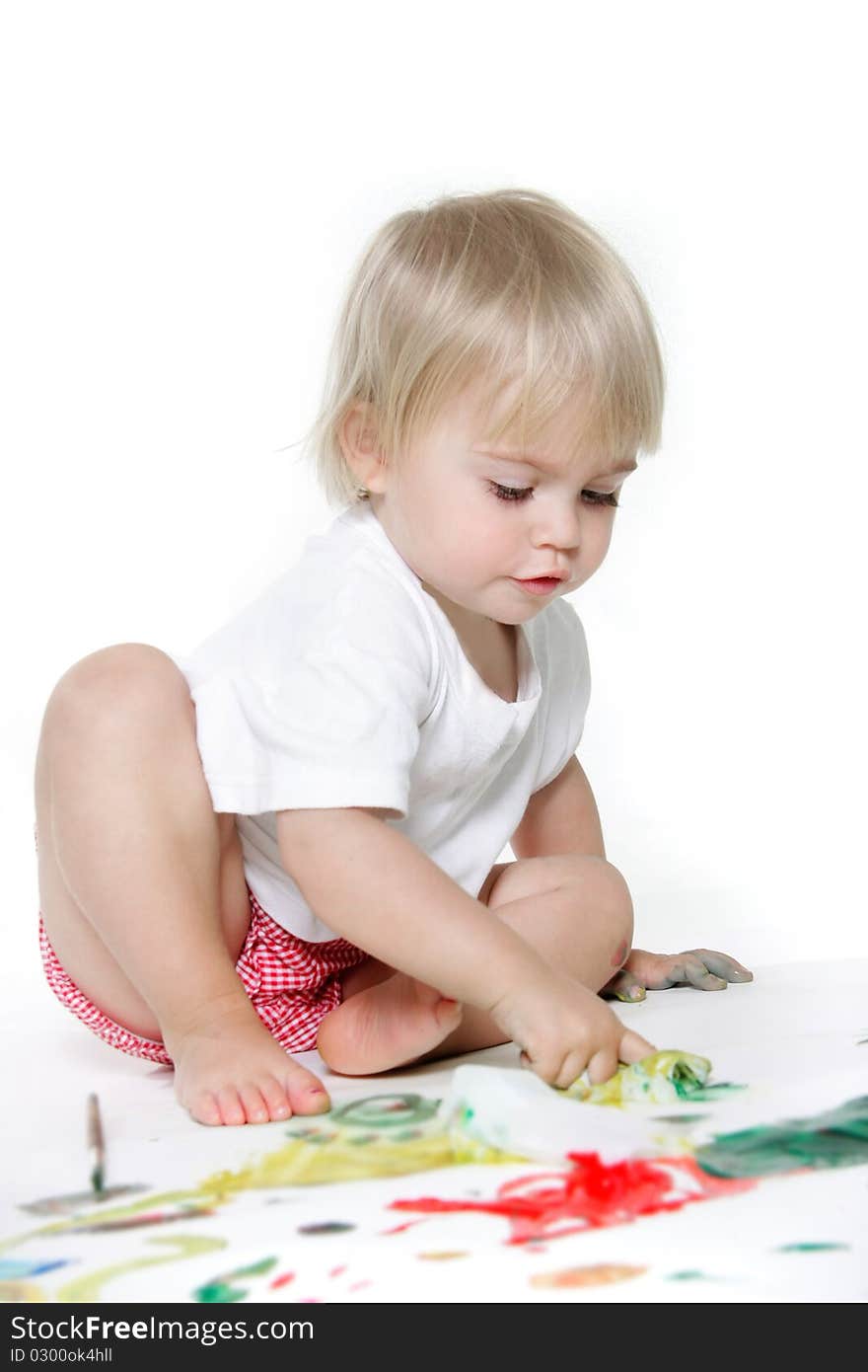 Cute toddler girl painting over white