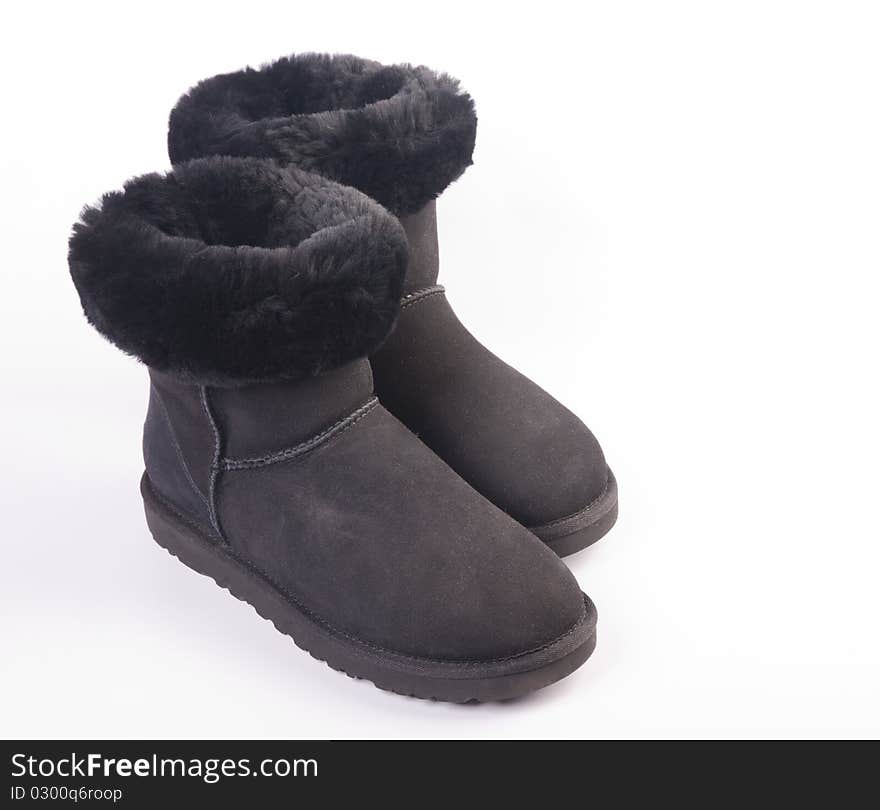 Winter fur boots over white background