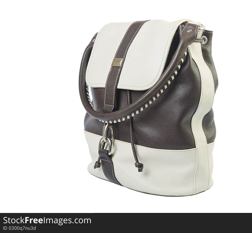 White and brown leather handbag over white background