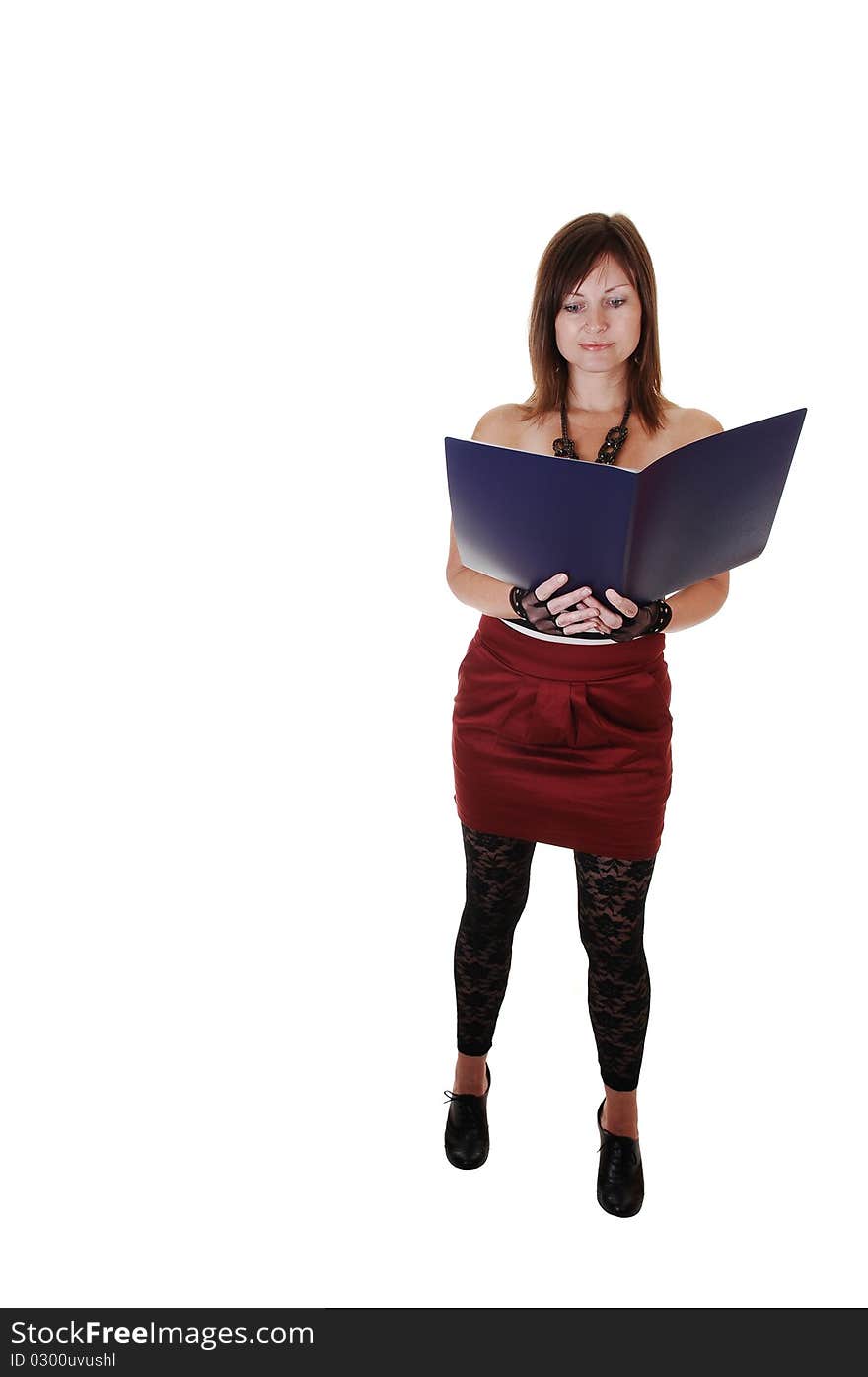 A middle aged woman reading in a big book, with black gloves and standing in the studio for white background. A middle aged woman reading in a big book, with black gloves and standing in the studio for white background.