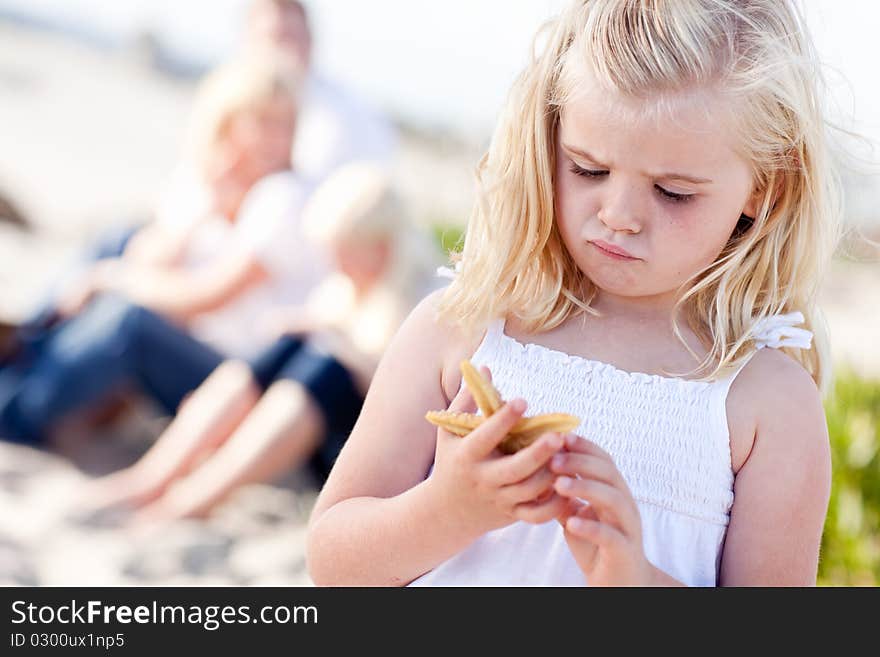 Adorable Little Blonde Girl with Starfish