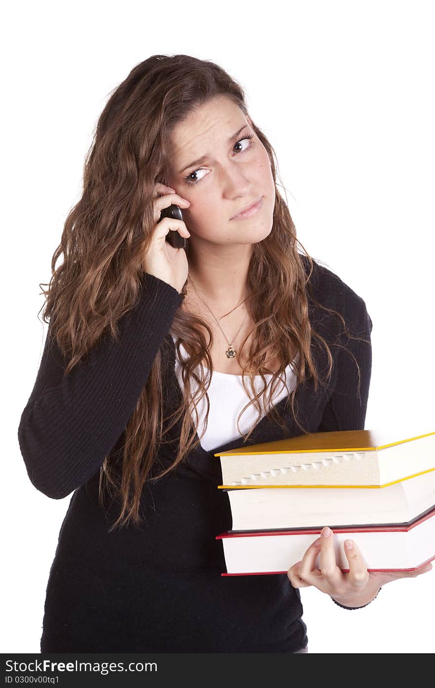 A woman has a stack of books and is on the phone. A woman has a stack of books and is on the phone.