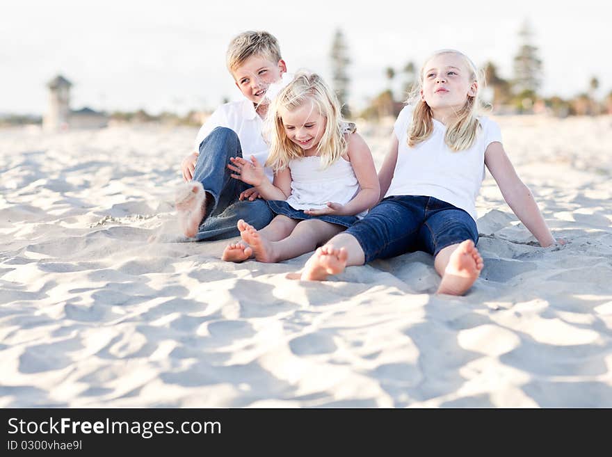 Young Sisters and Brother Having Fun at the Bea