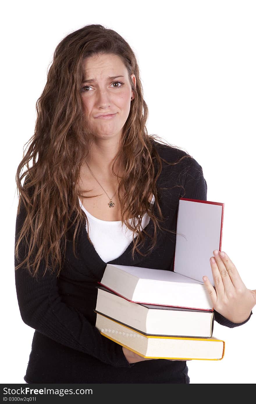 A woman is holding a stack of books and looks frustrated. A woman is holding a stack of books and looks frustrated.