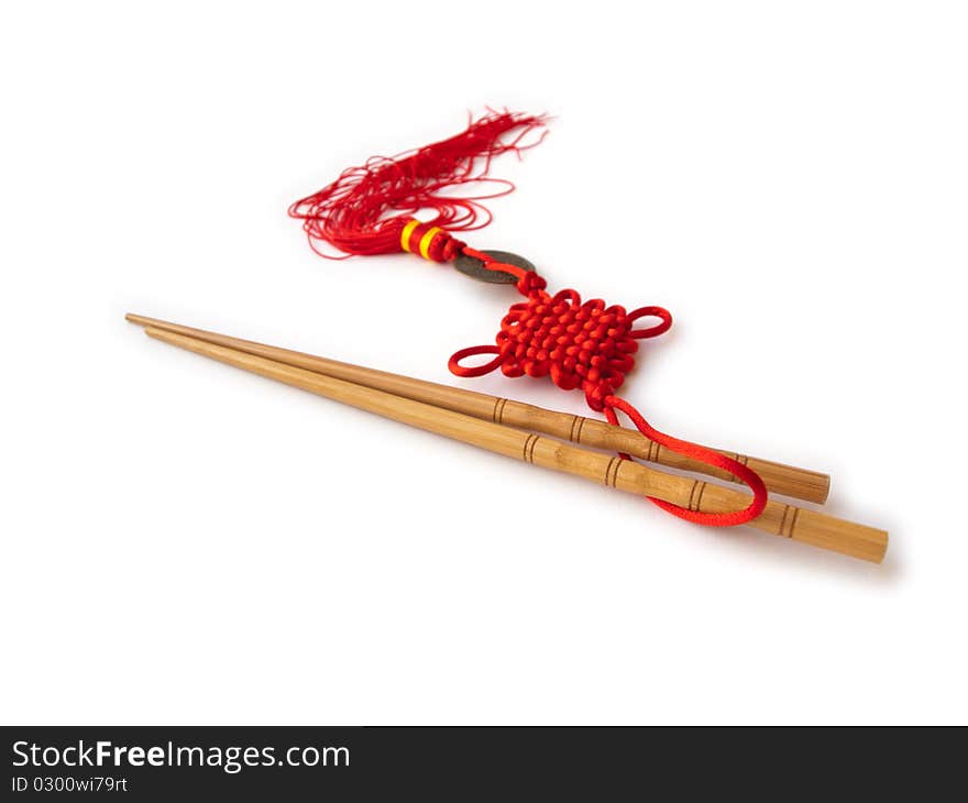 Chopsticks and red oriental decoration isolated on white