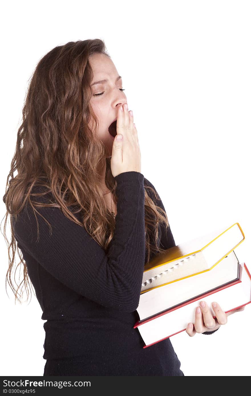 A woman is holding a stack of books and yawning. A woman is holding a stack of books and yawning.