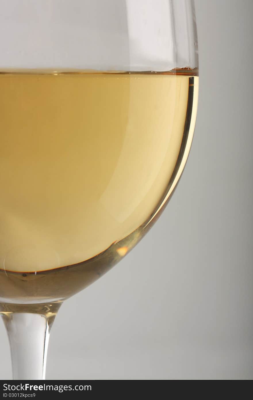 Close-up of a white wine glass over gray background