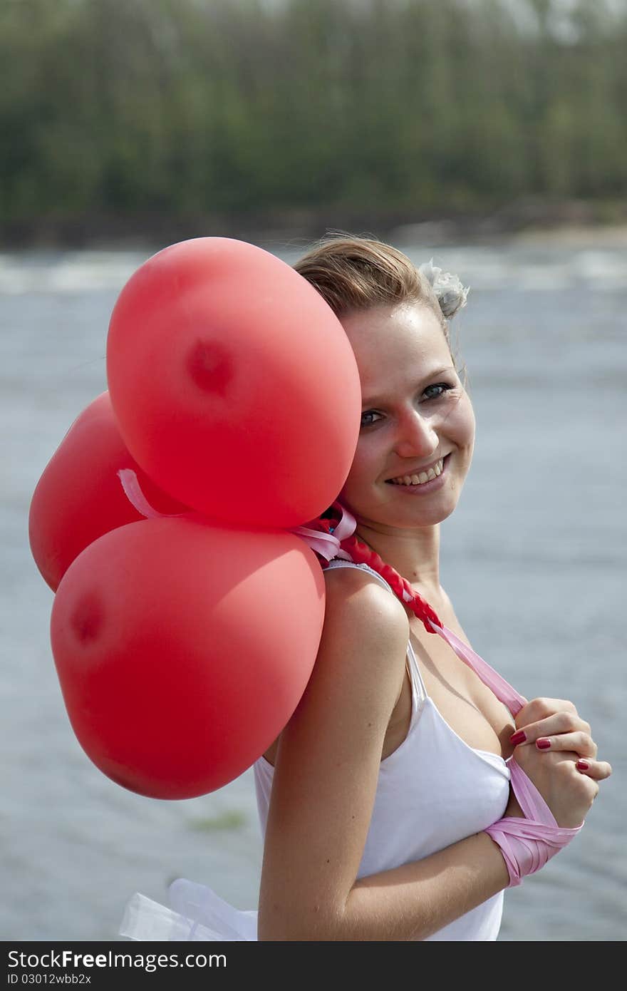 Young woman with balloons on the beach. Young woman with balloons on the beach