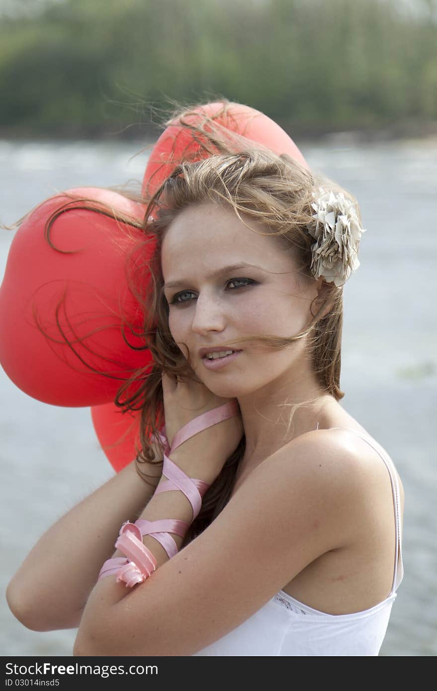 Young  woman with balloons on the beach. Young  woman with balloons on the beach