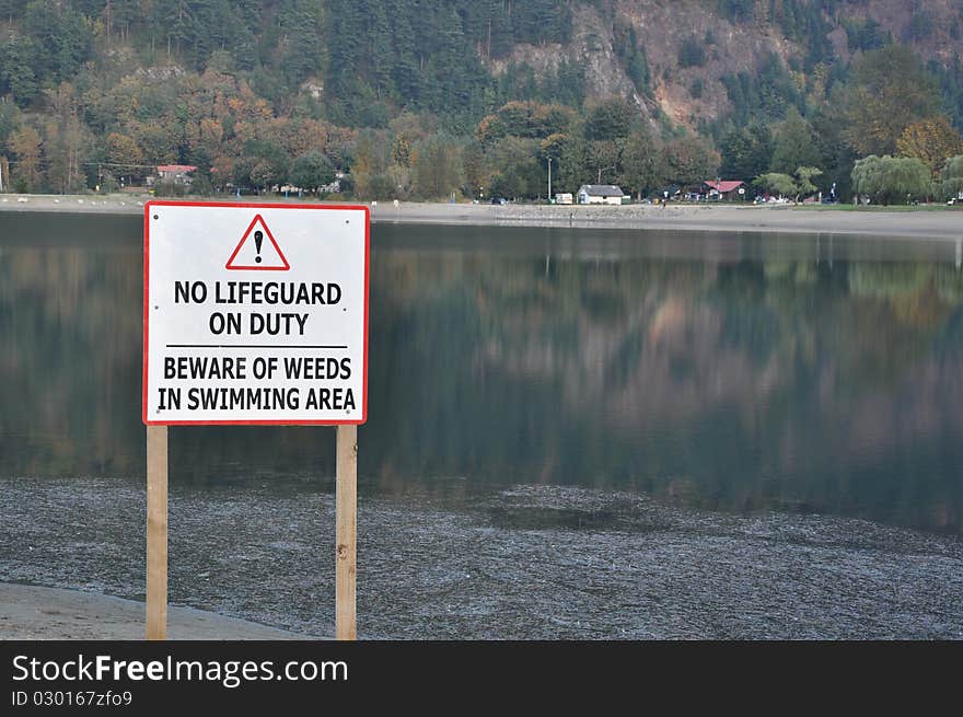 No lifeguard sign with nature view of Harrison Hot Springs