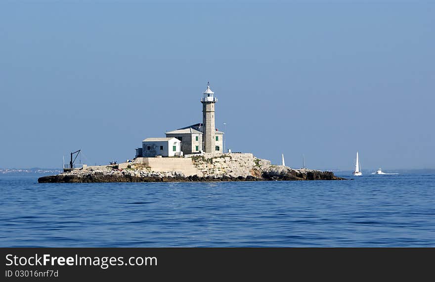 Lighthouse in the sea on a clear cloudless weather