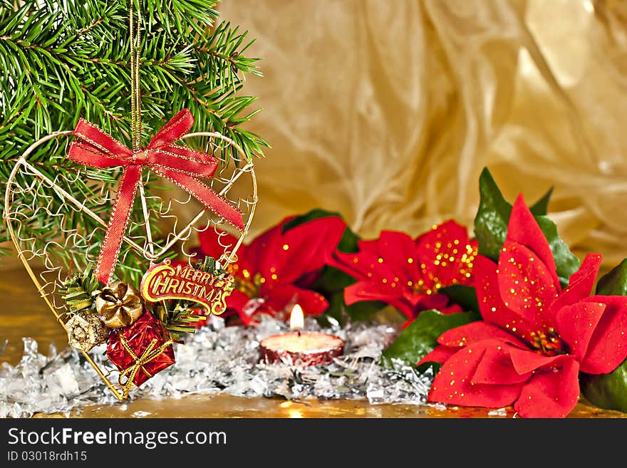 Christmas composition, fir branch with the decor, Poinsettia on gold background. Christmas composition, fir branch with the decor, Poinsettia on gold background.