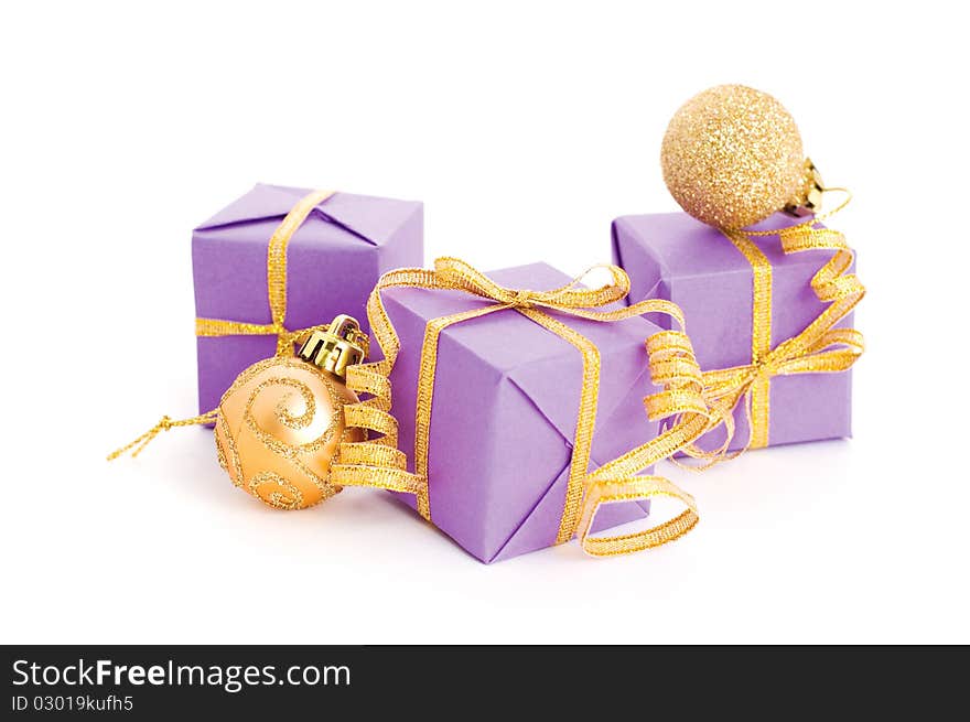 Lilac boxes with golden ribbon isolated on white background. Lilac boxes with golden ribbon isolated on white background