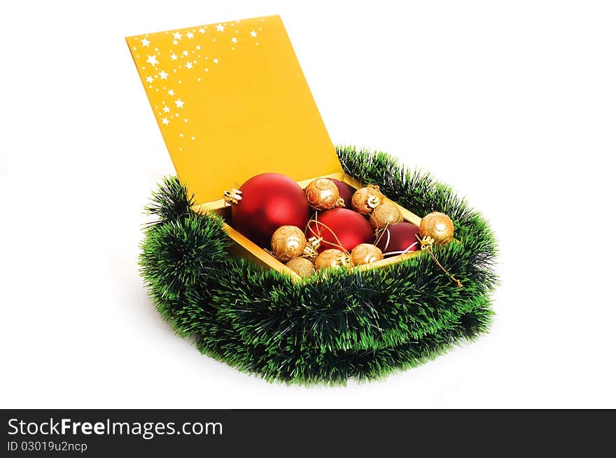 Golden box with christmas balls isolated on white background. Golden box with christmas balls isolated on white background