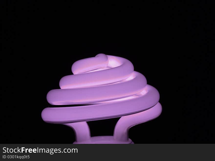 Energy efficient fluorescent light bulb on black background