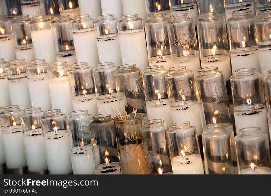 Rows of burning candles in the church. Rows of burning candles in the church