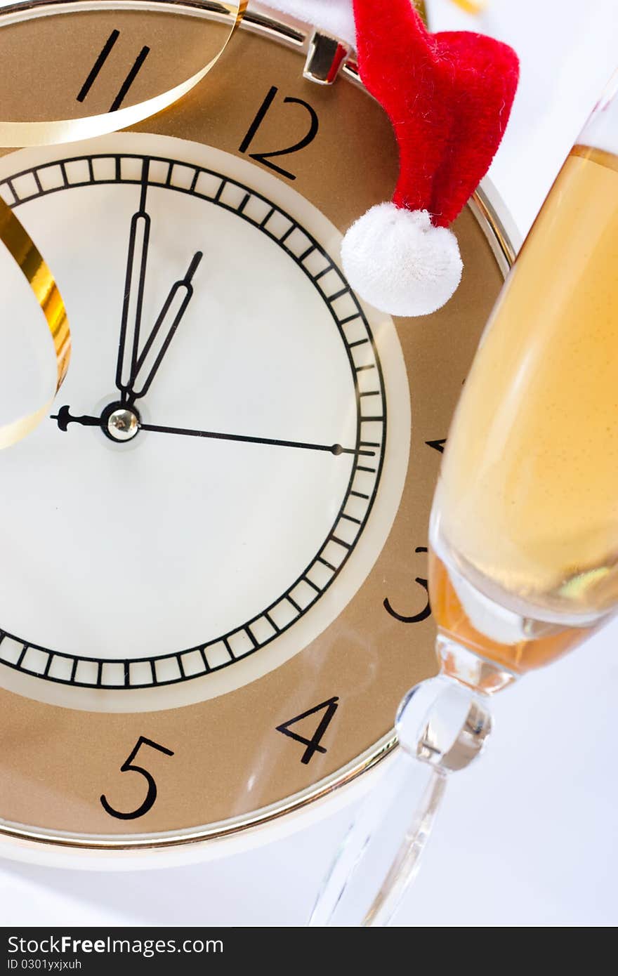 The clock showed almost 12.00 in the Santa hat and champagne. The clock showed almost 12.00 in the Santa hat and champagne