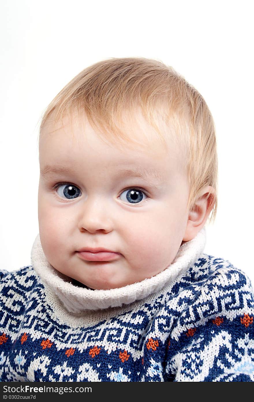 Portrait of confused baby in switter on a white isolated background