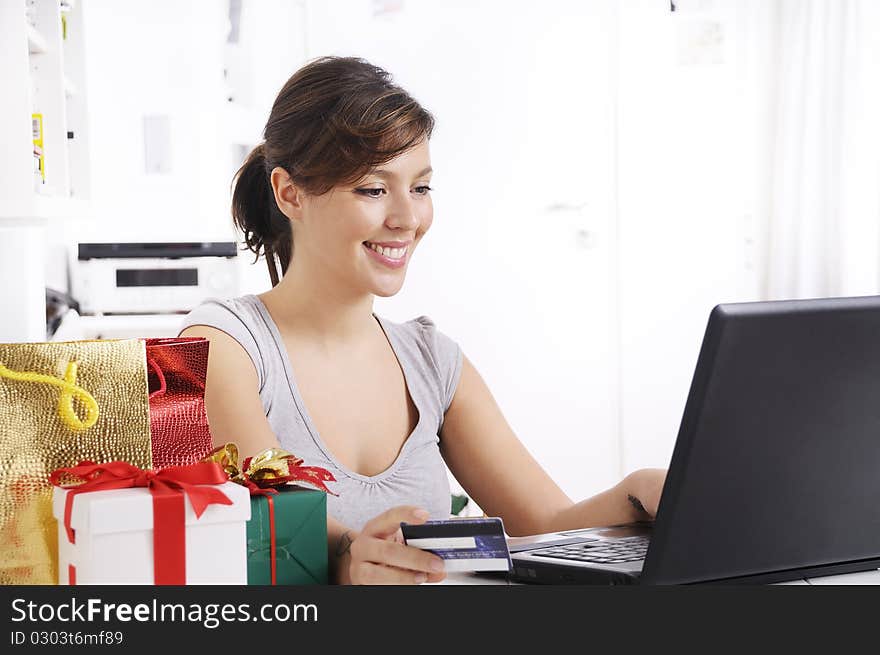 Happy shopping on-line of young woman with laptop on internet. Happy shopping on-line of young woman with laptop on internet