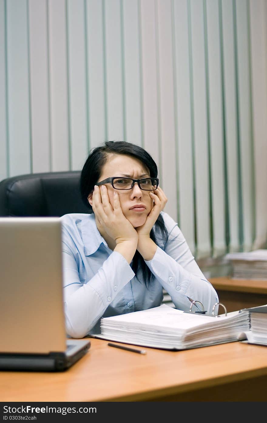 Young girl at office behind a table