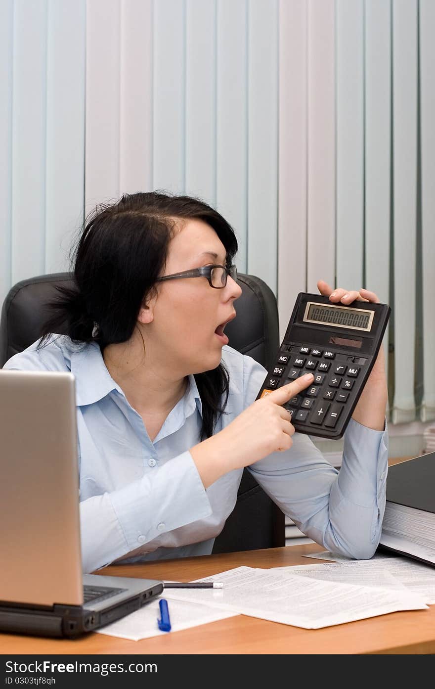 Young girl at office behind a table