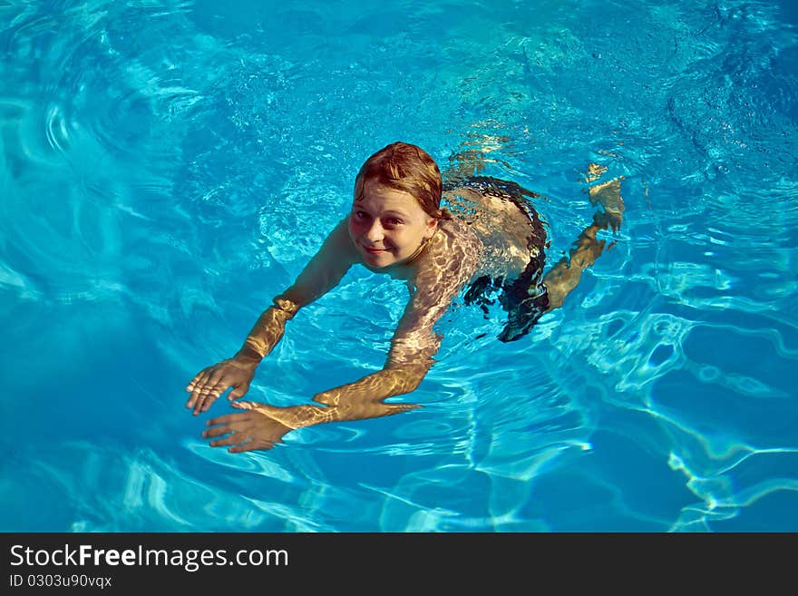 Boy has fun in the pool. Boy has fun in the pool