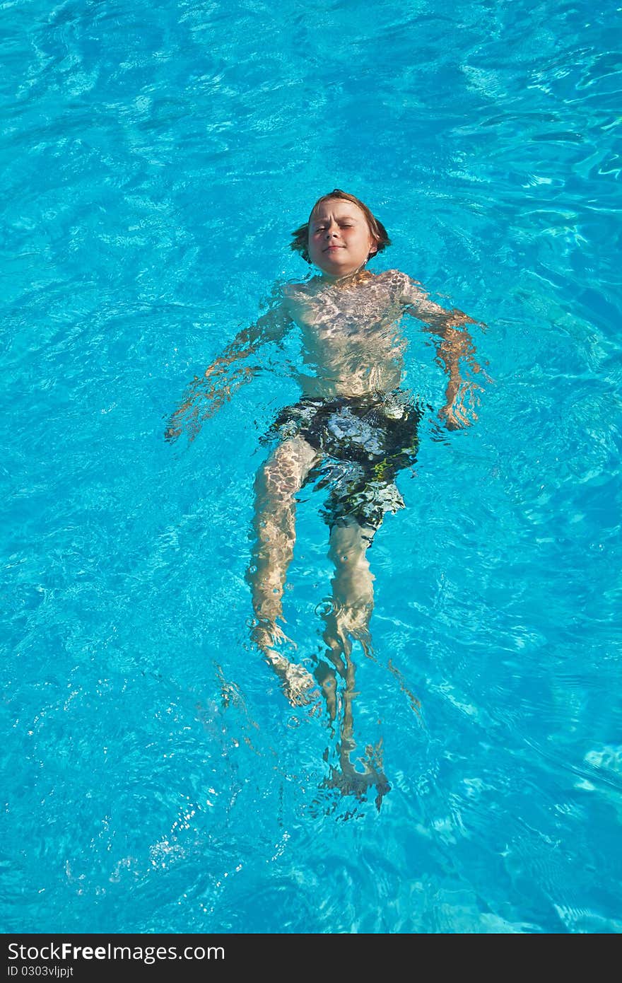 Boy has fun in the pool. Boy has fun in the pool