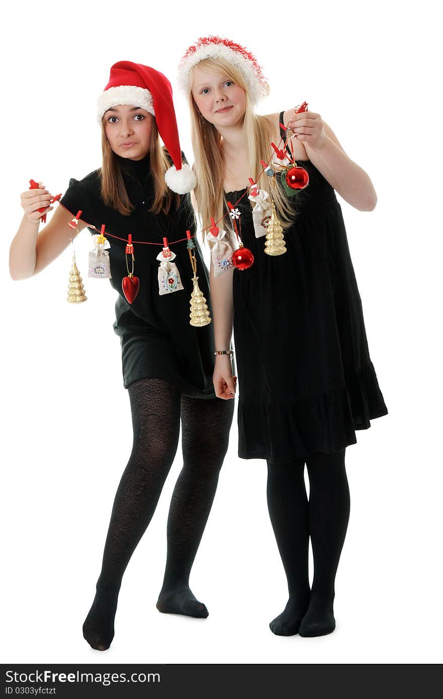 Two girls in hat santa with festoon on white background