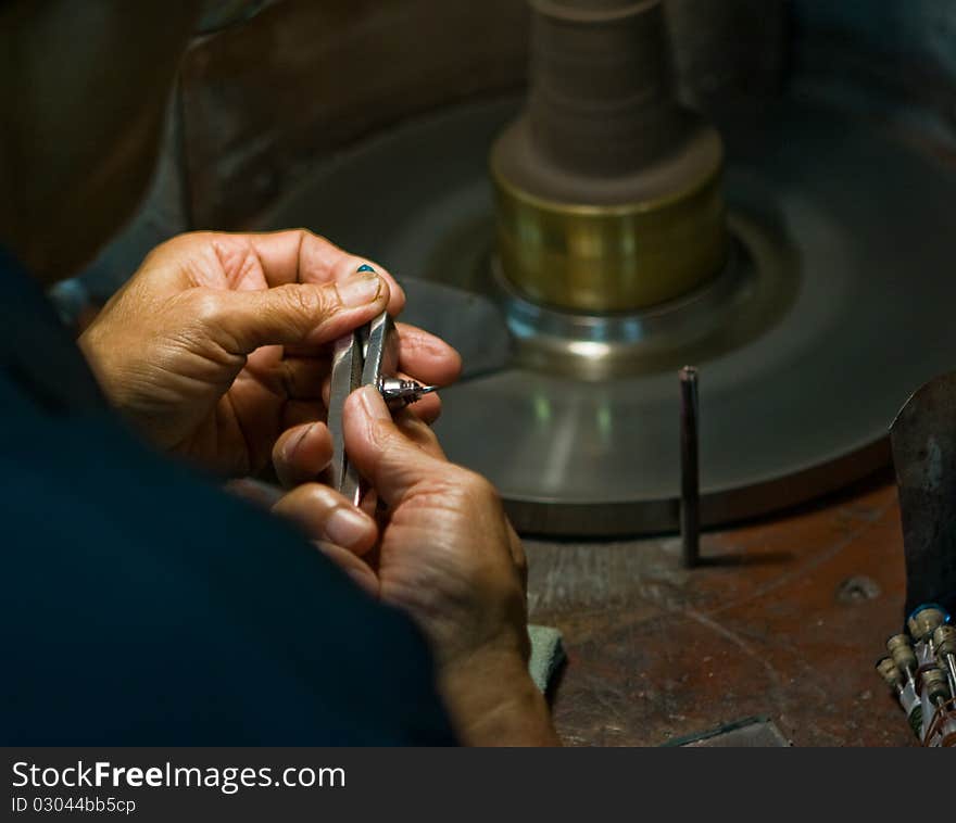 Worker polishing a gem stone. Worker polishing a gem stone