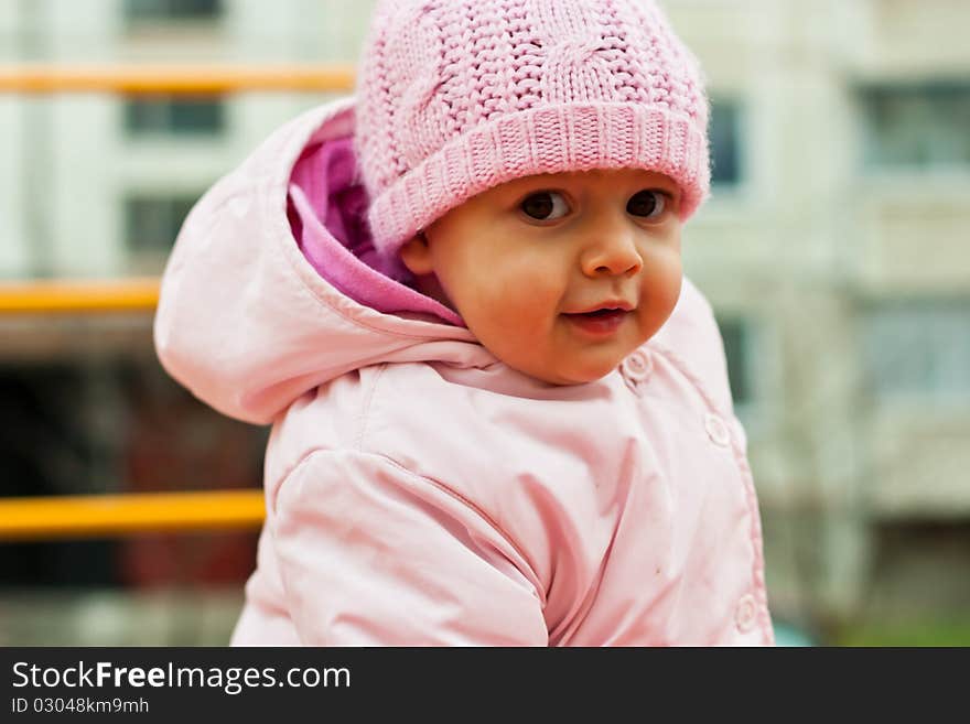 Beautiful baby smiling outdoor in playground. Beautiful baby smiling outdoor in playground