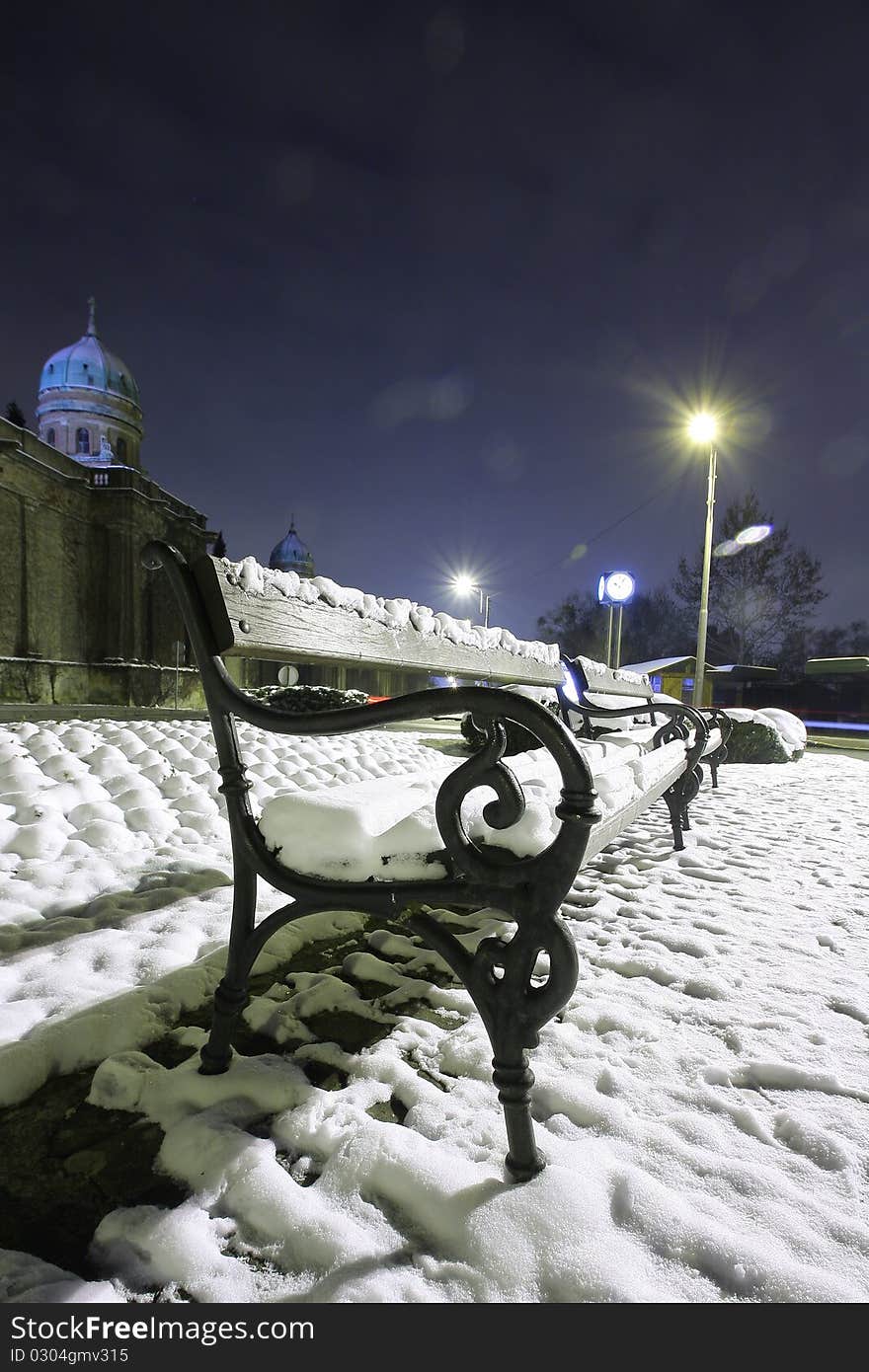 Snow on the bench in the park