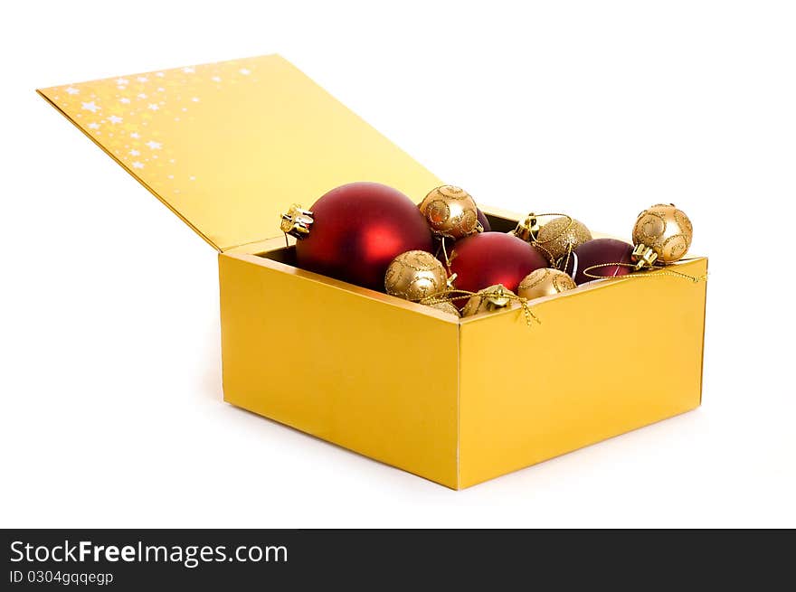 Golden box with christmas balls isolated on white background. Golden box with christmas balls isolated on white background