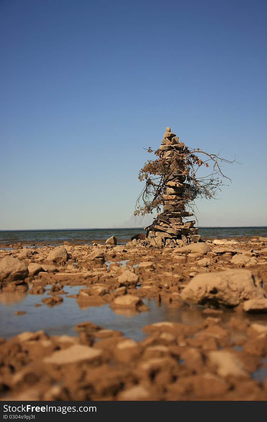 Small rock edifice waypoint marker on the shore of lake Huron, Mackinac Island