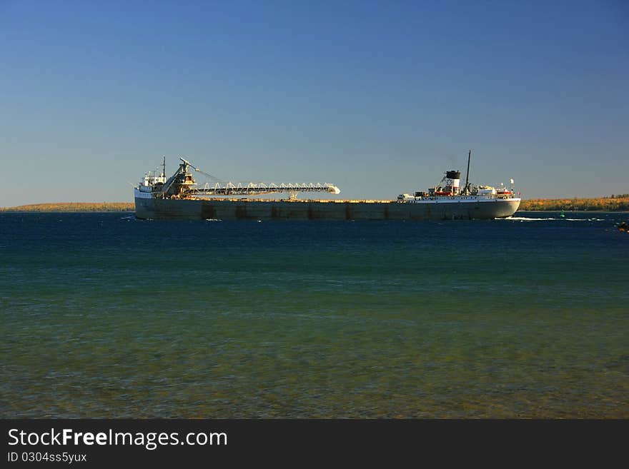 A great lakes freighter transits round island passage Mackinac island Michigan Lake Huron