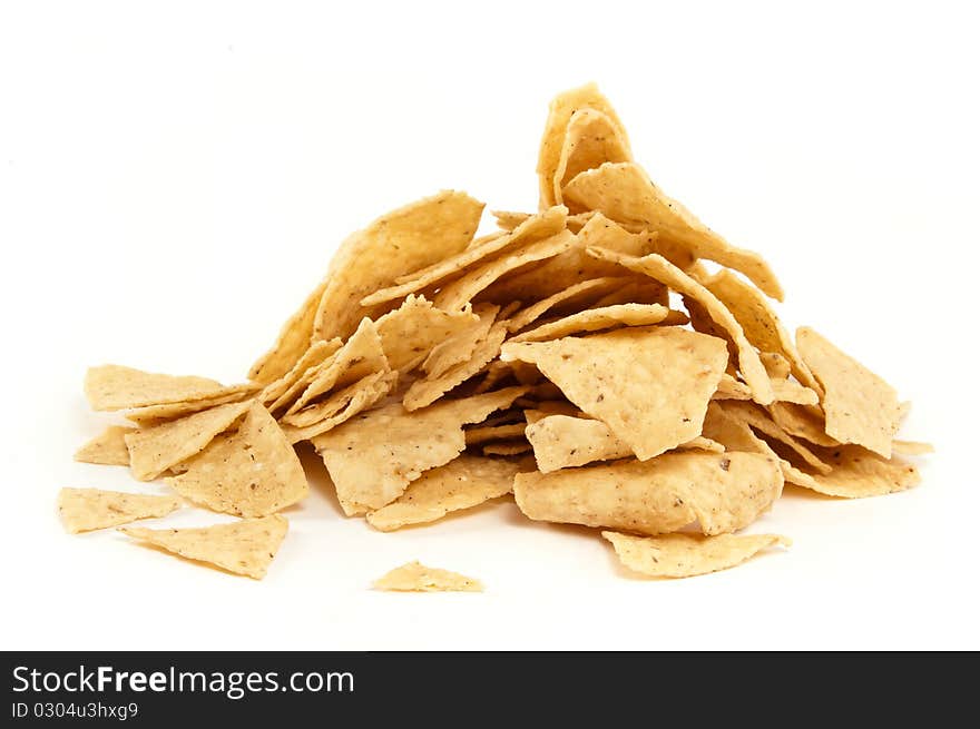 A pile of mexican nachos on white background. A pile of mexican nachos on white background