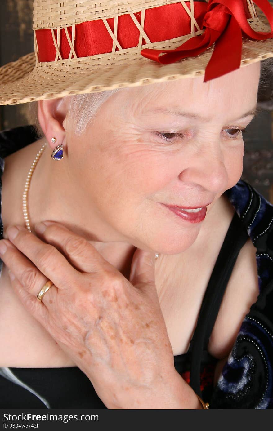 Beautiful female wearing a straw hat with red ribbon. Beautiful female wearing a straw hat with red ribbon