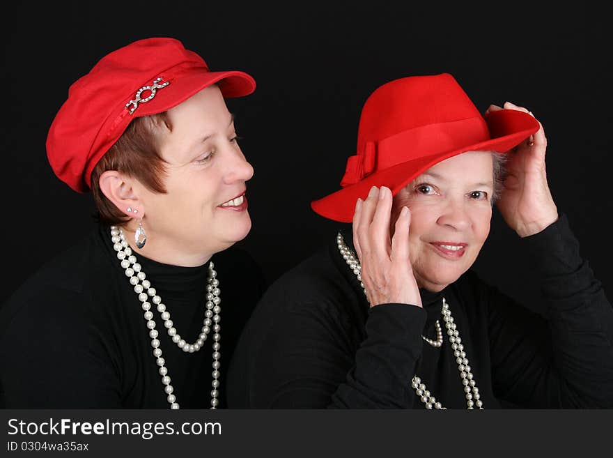 Adult mother and daughter wearing red hats