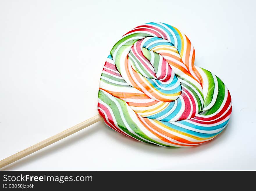 Close up of colourful lollipop, heart shape. Close up of colourful lollipop, heart shape.