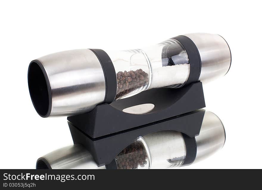 Series. A glass grinder of pepper isolated on a white background