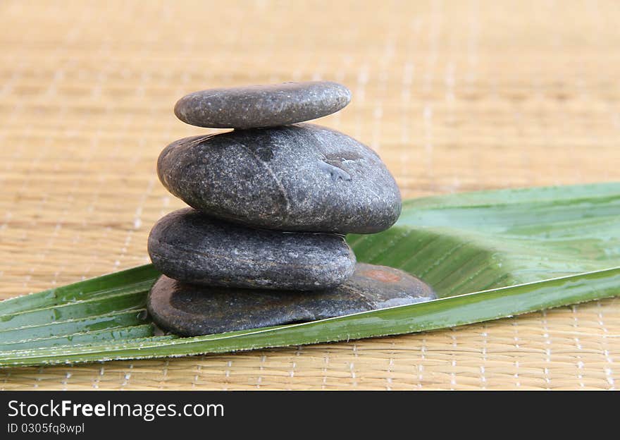 Spa treatment .beautiful spa background.zen stones and leaf on bamboo mat