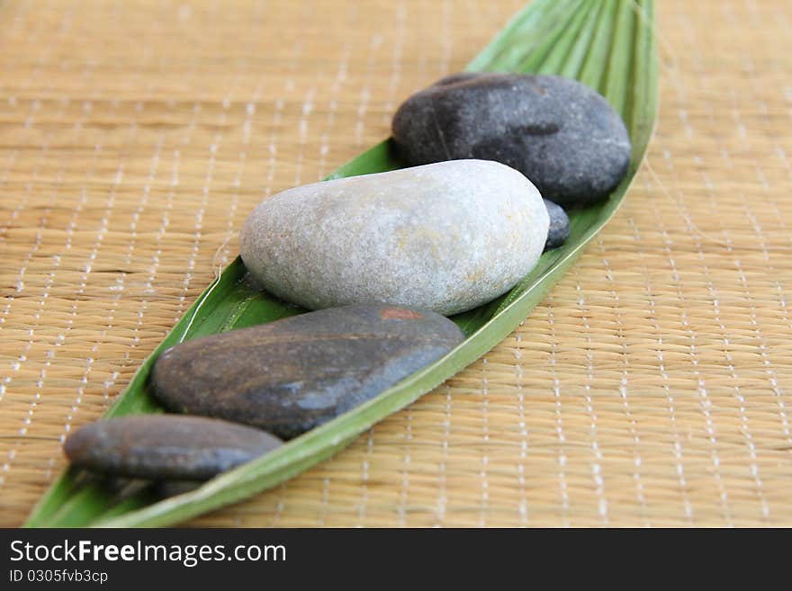 Spa treatment .beautiful spa background.zen stones and leaf on bamboo mat