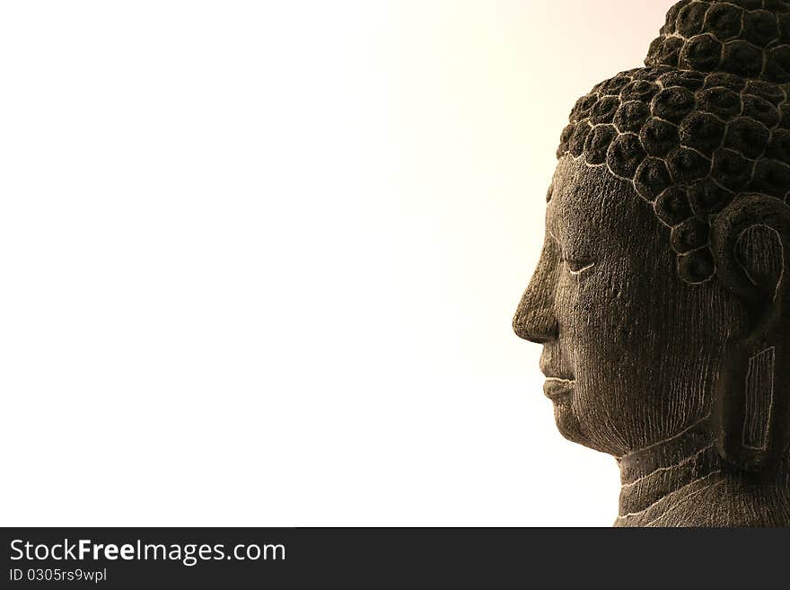 Embossed head and face of a Buddha statue.