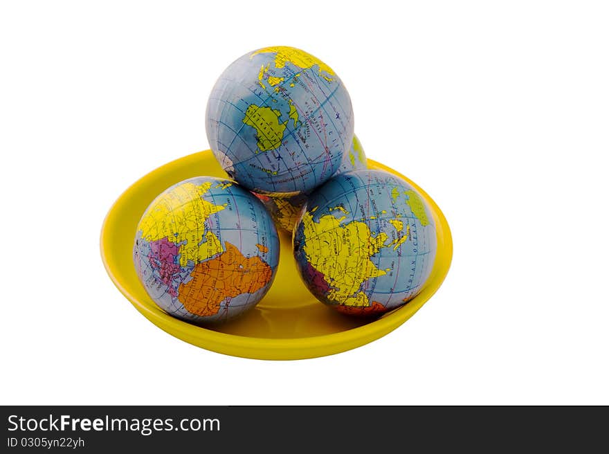 Three globes on the plate, isolated on the white. Three globes on the plate, isolated on the white