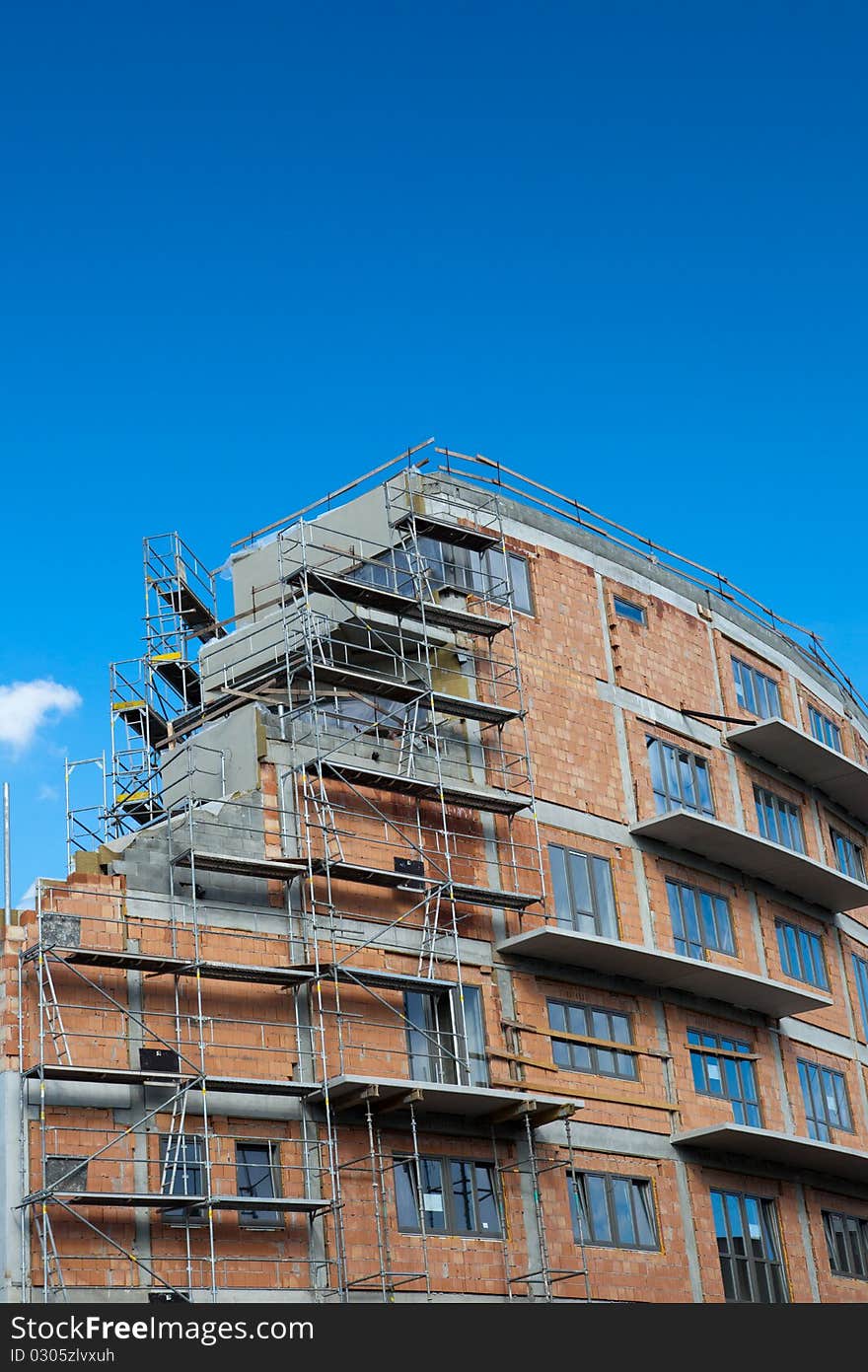 Residential building construction site on a lovely summer day (color toned image)