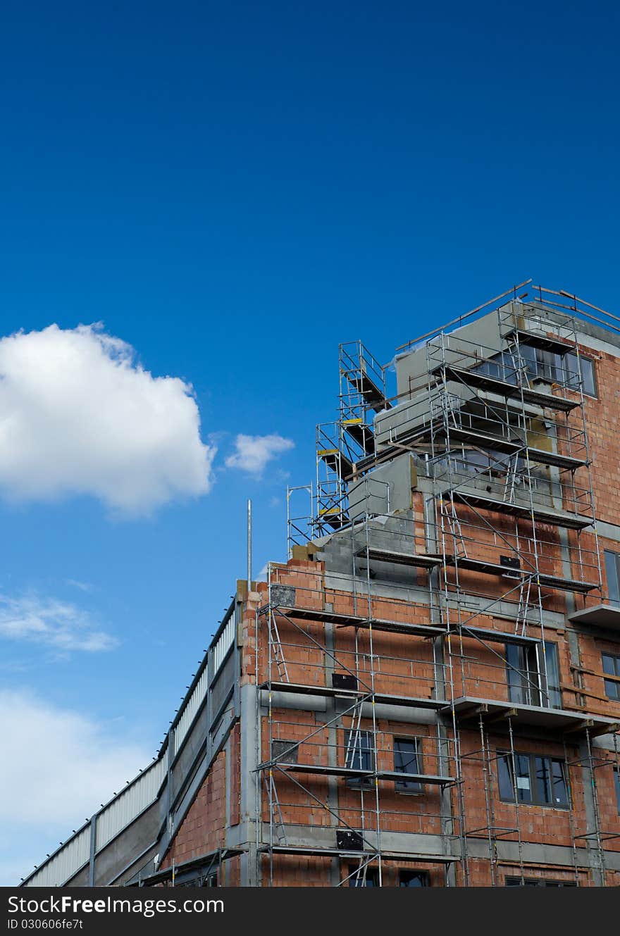 Residential building construction site on a lovely summer day (color toned image)