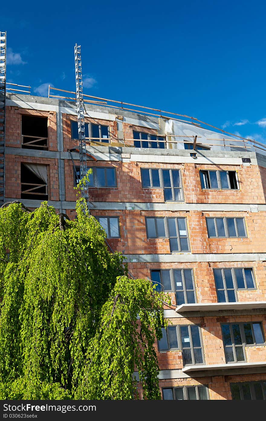 Residential building construction site on a lovely summer day (color toned image)