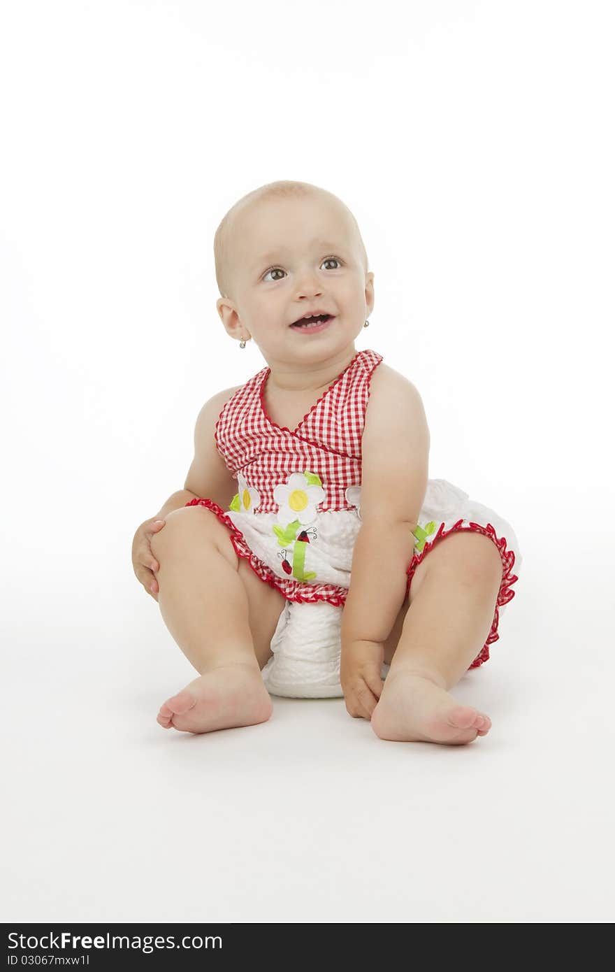 Smiling child sit, on white background.