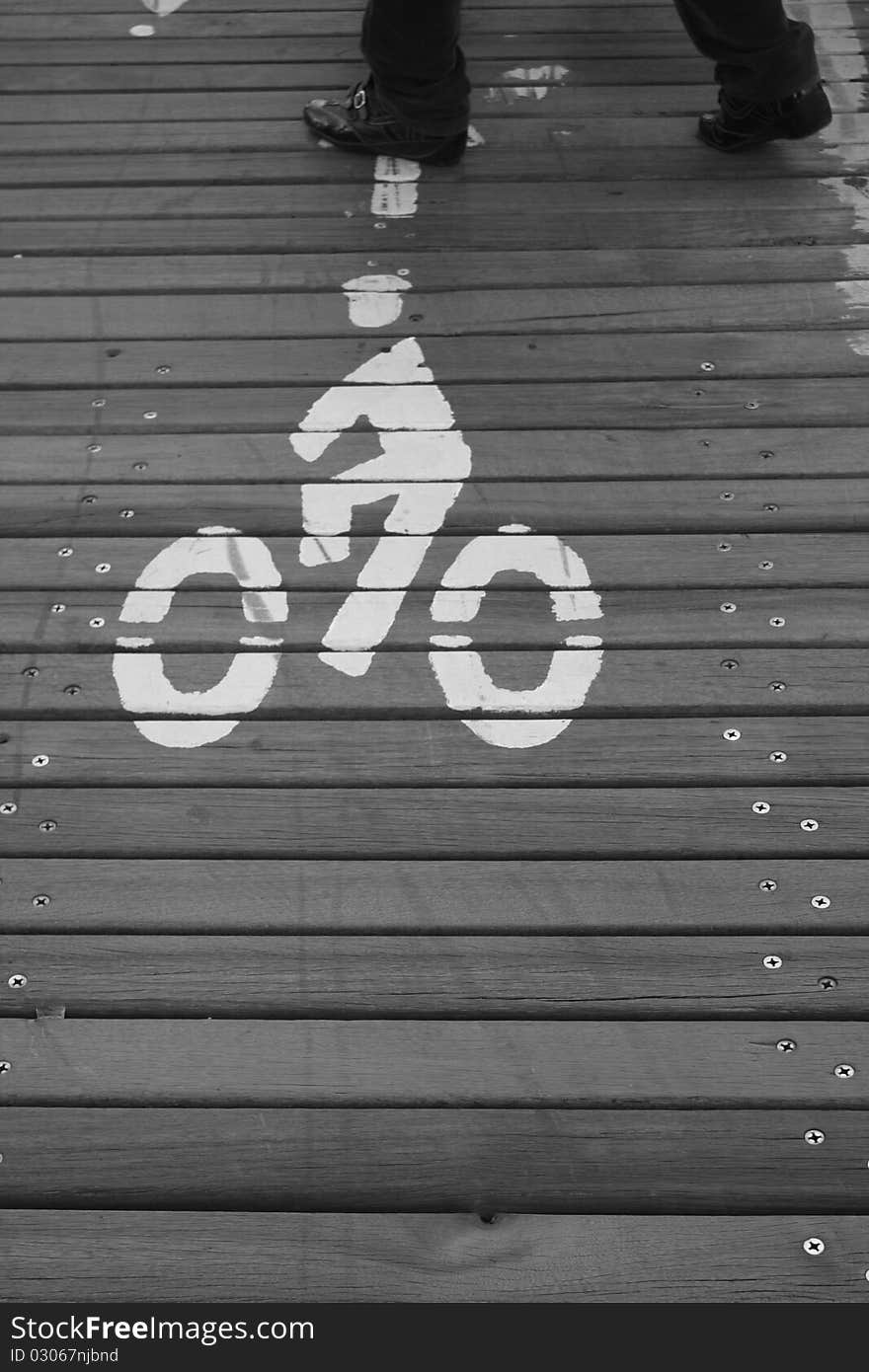 A pedestrian walking on the cycle path on Brooklyn Bridge, New York