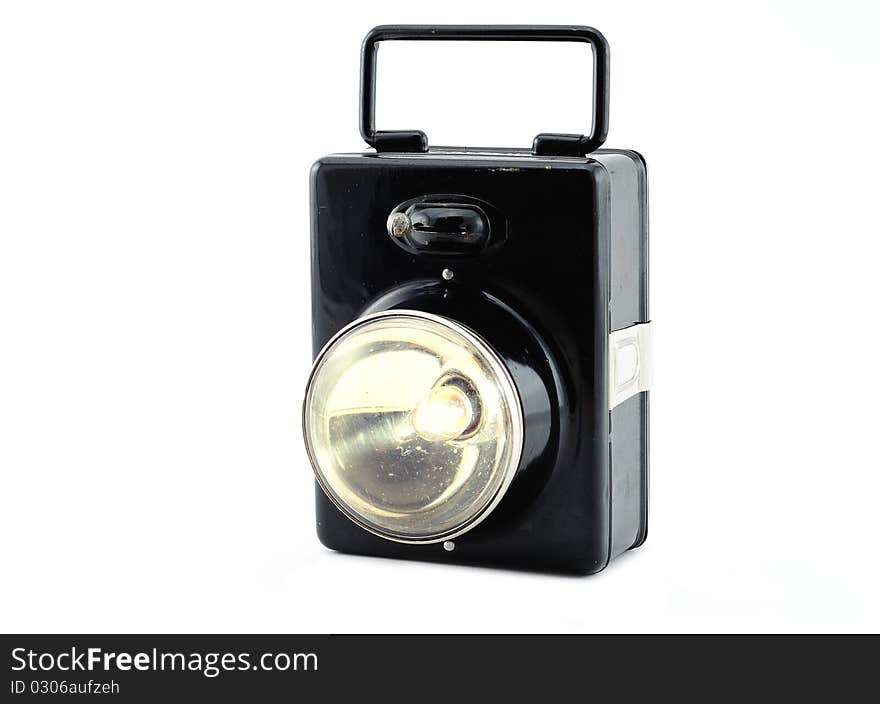 Old pocket flashlight on a white background.